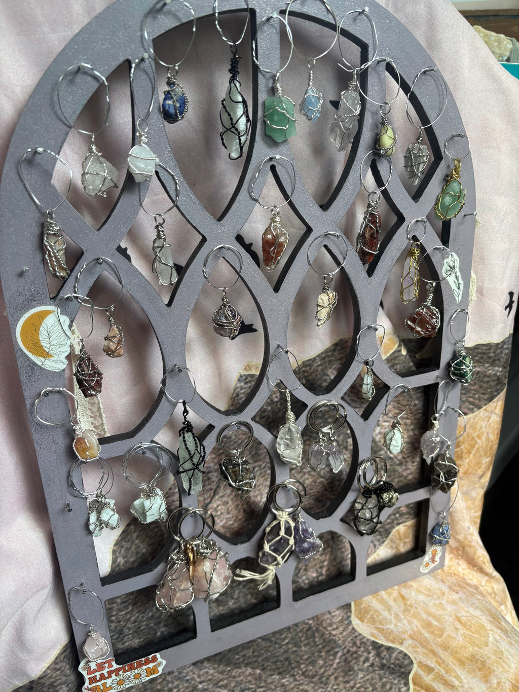 Collection of crystal pendants on a decorative stand with a soft background