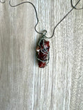 Necklace with a red calcite stone pendant