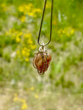 Necklace with a rough carnelian agate pendant wrapped in copper wire