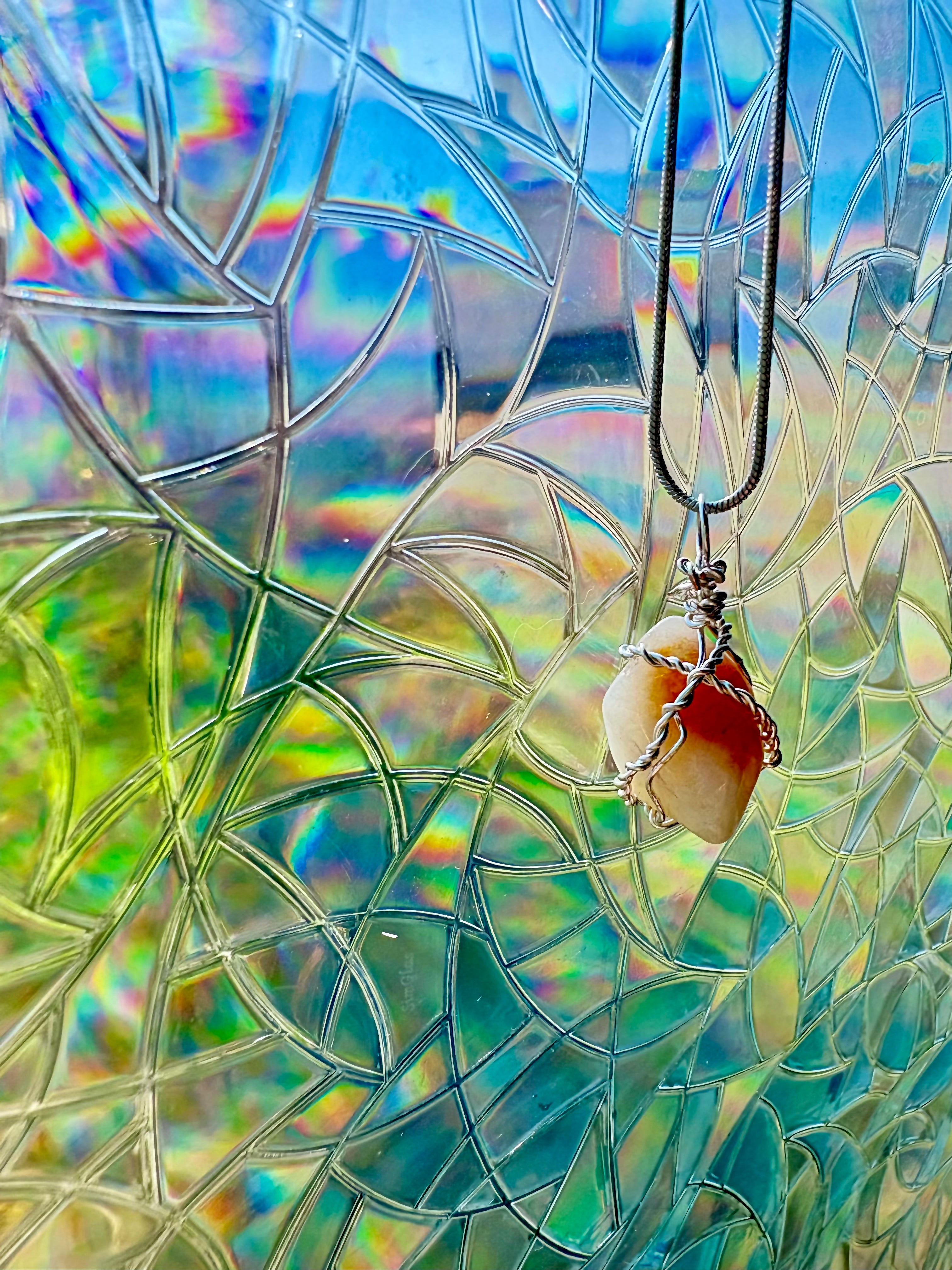 Necklace with a pendant against a colorful stained glass window background