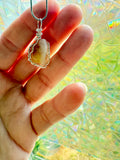 Hand holding a stone pendant